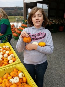 My cutie with her collection of cute pumpkins.